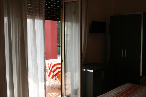 a room with a window with a view of a patio at Hotel Renato in Sesto San Giovanni
