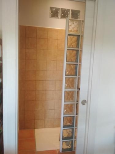 a walk in shower with a shelf of shoes at La terraza in Banyoles