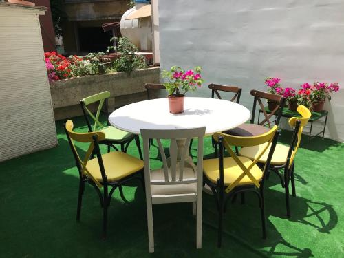 a white table and chairs with flowers on a patio at Paris Garden Hotel Istanbul in Istanbul