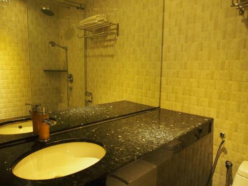 a bathroom with a sink and a shower at Venus Boutique Hotel in Melaka