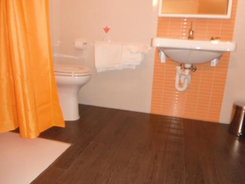 a bathroom with a toilet and a sink at Hotel Renato in Sesto San Giovanni