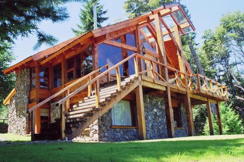 a log cabin with a staircase on a house at Colina Del Manzano in Villa La Angostura