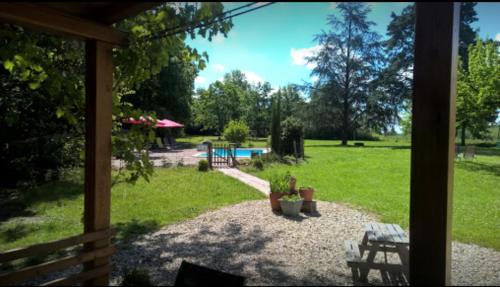a view of a garden from the porch of a house at La Forestière in Monclar-de-Quercy