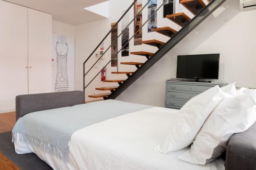 a bedroom with a bed and a staircase at Casas do Teatro in Porto