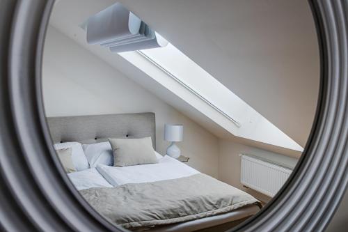 a bedroom with a large bed in a attic at Gold Art Apartments in Prague