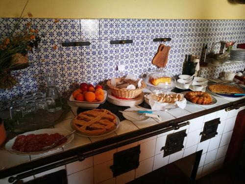 a kitchen counter with many plates of food on it at La Zizzania e il Mandarino in Roccagloriosa