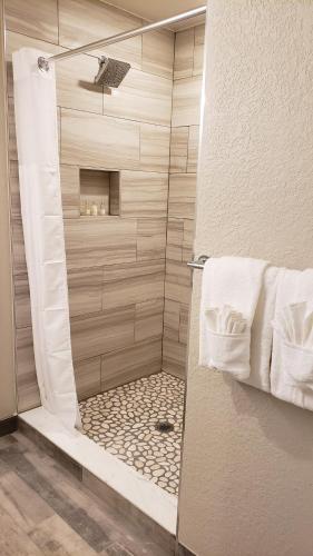 a shower with a glass door in a bathroom at Barefoot Beach Club in St. Pete Beach