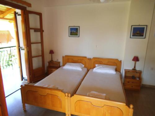 a bedroom with two beds and a open door at Villa Xenos in Kalamaki