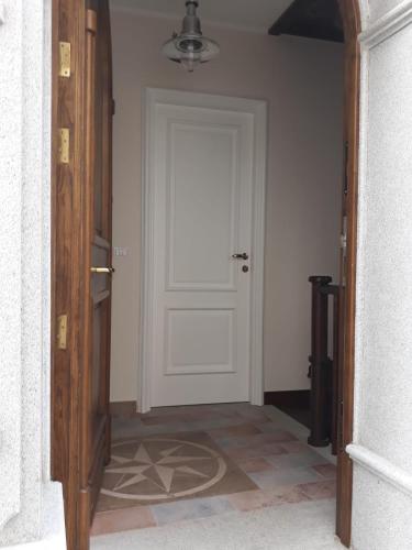a hallway with a white door and a tile floor at La Sciabica in Scilla