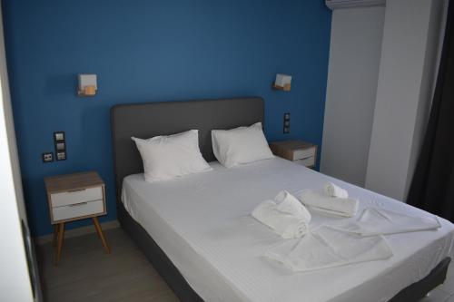 a bed room with a white bedspread and white pillows at Christina Studios & Apartments in Parga