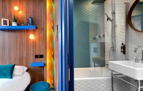 a bathroom with a sink and a shower at Hôtel Montmorency & Spa in Carcassonne