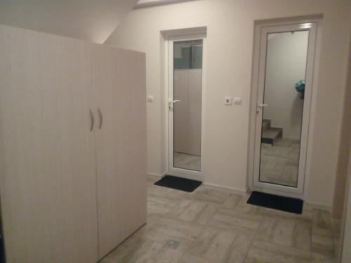 an empty room with a door and a mirror at Хостел Атлас - Hostel Atlas in Blagoevgrad