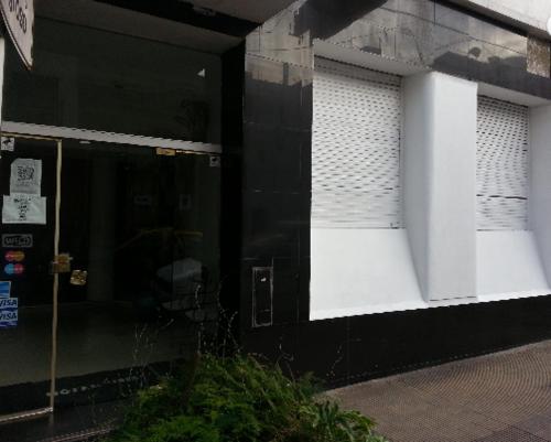 a black and white building with a glass door at Hotel Isis in Buenos Aires