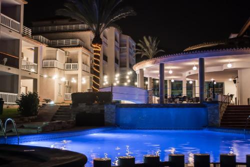 a pool in front of a building at night at Ona Ogisaka Garden in Denia