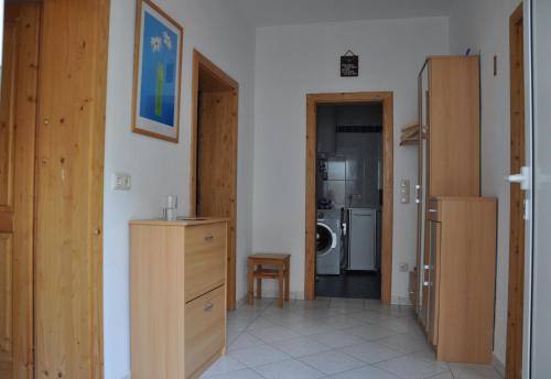 a room with wooden cabinets and a kitchen at Ferienhaus Resi in Illmitz