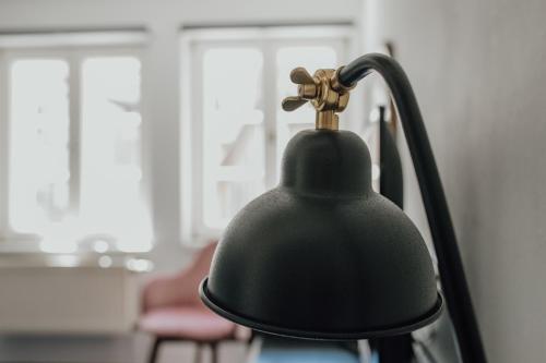 a black lamp sitting on top of a chair at Magni Boutique Hotel in Braunschweig