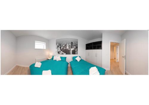 a living room with two blue couches in a room at SWUITE GALWAY in Galway