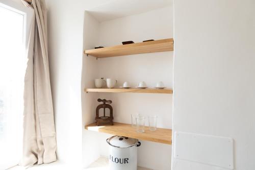 a room with wooden shelves and a window at A casa di Dany in Polignano a Mare