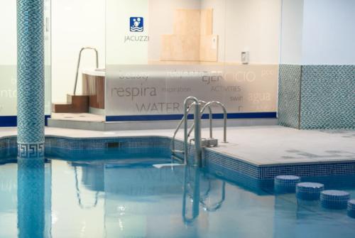 a swimming pool with a shower in a building at Ona Ogisaka Garden in Denia