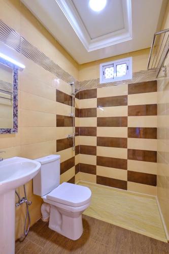 a bathroom with a toilet and a sink at Hotel Central Palace in Marrakech