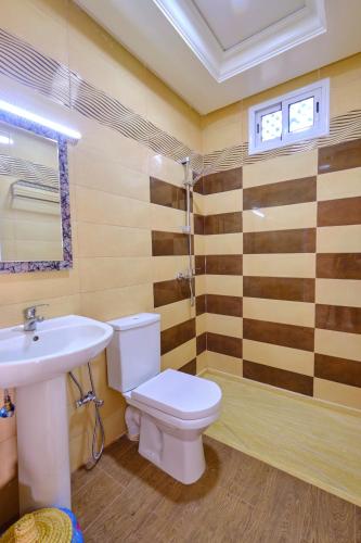 a bathroom with a toilet and a sink at Hotel Central Palace in Marrakech