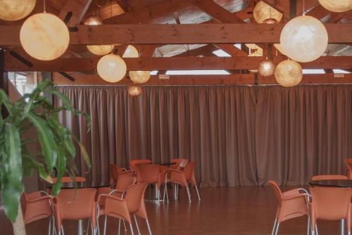 a row of tables and chairs in a room at Ona Ogisaka Garden in Denia