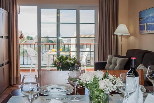 a dining room table with wine glasses and flowers on it at Ona Ogisaka Garden in Denia
