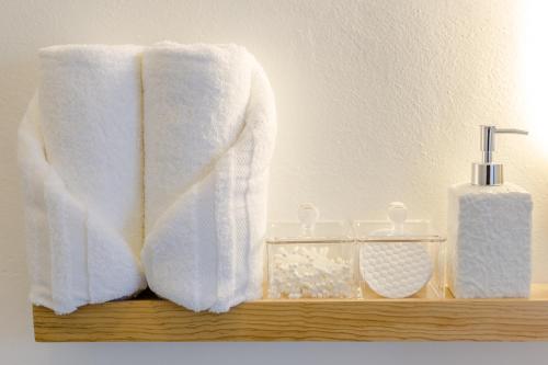 a towel and a bottle of soap on a shelf at Studios Downtown Cancun in Cancún