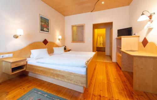 a bedroom with a large bed in a room at Landhotel Pacher in Obervellach
