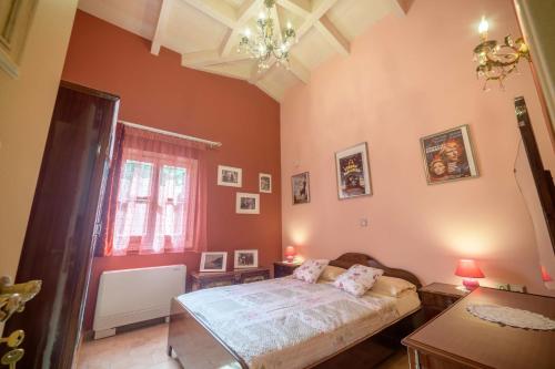 a bedroom with a bed and a window at Villa Nitsa in Corfu Town