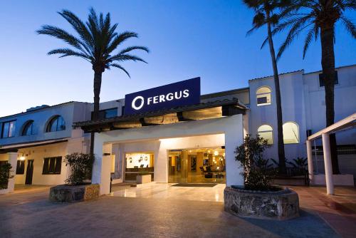 a building with a sign on the front of it with a palm tree at FERGUS Style Bahamas in Playa d'en Bossa