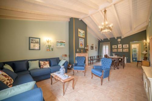 a living room with a blue couch and chairs at Villa Nitsa in Corfu Town