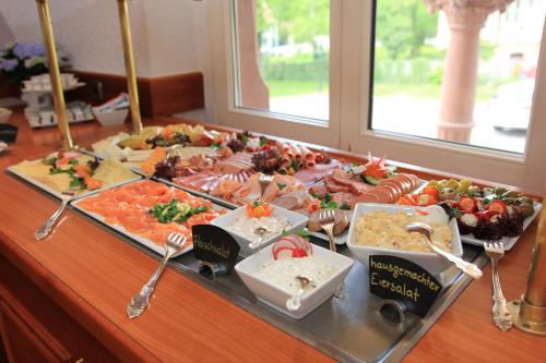 a buffet with many different types of food on a table at Hotel Erbprinzenpalais in Wernigerode