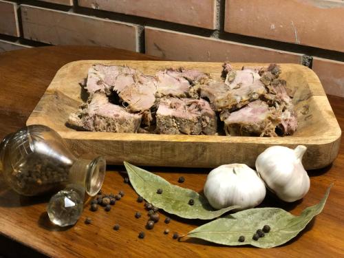 a cutting board with meat and garlic on a table at Bloom Boutique Hotel in Tbilisi City