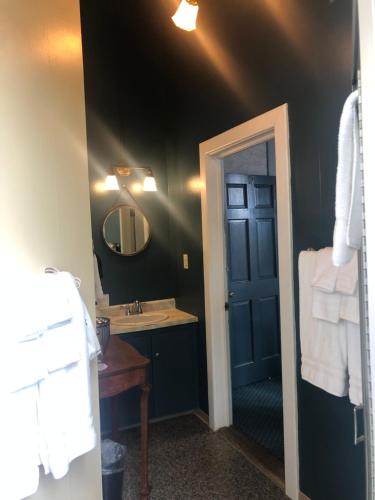 a bathroom with a sink and a mirror at The Inn at 2nd & C in Eureka