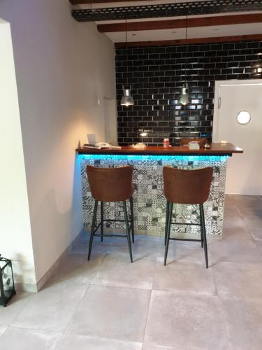 a bar with two chairs in front of a counter at El Capitan nähe Movie Park in Schermbeck