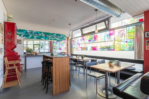 a restaurant with tables and chairs and stained glass windows at Bettstatt-Neustadt in Luzern