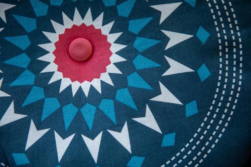 a red button on a blue and white patterned cloth at Bettstatt-Neustadt in Luzern