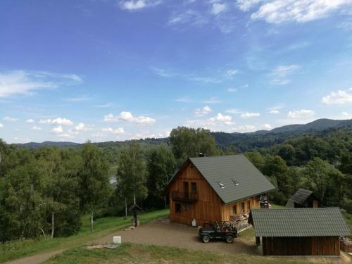 an aerial view of a barn with a truck parked next to it at U Malwiny in Rajskie Sakowczyk