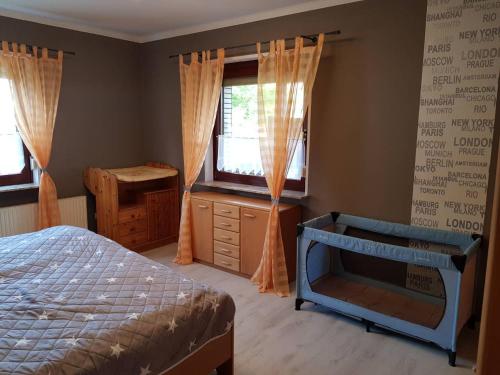 a bedroom with a bed and a dresser and a window at Wagner's Wohlfühl Wohnung (WWW) in Rollshausen