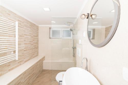 a bathroom with a sink and a mirror at Solymar in Posedarje