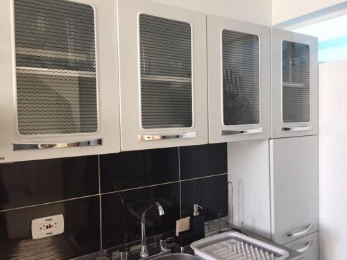 a kitchen with four windows above a sink at SPACIOUS STUDIO CENTRAL LOCATION (201) in Bogotá