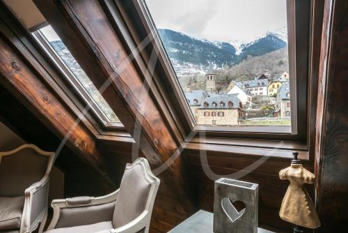 a room with a chair and a window with a view at BACIVER in Aubert