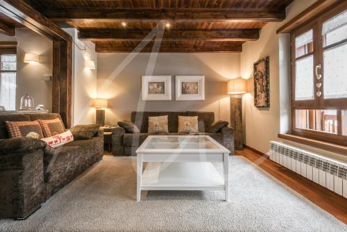 a living room with a couch and a table at BACIVER in Aubert