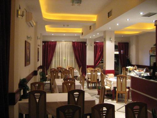 a dining room with tables and chairs in a restaurant at Villa Rimari in Ohrid