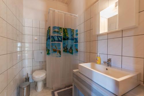 a bathroom with a sink and a toilet at Lucia's Home in Skala Potamias