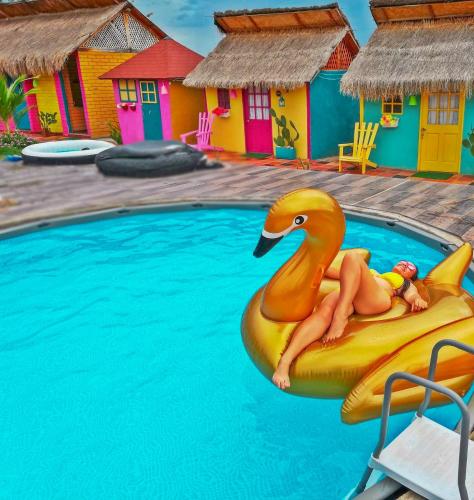 a woman sitting on a rubber duck on a raft in a pool at Dunas Tatacoa in Villavieja