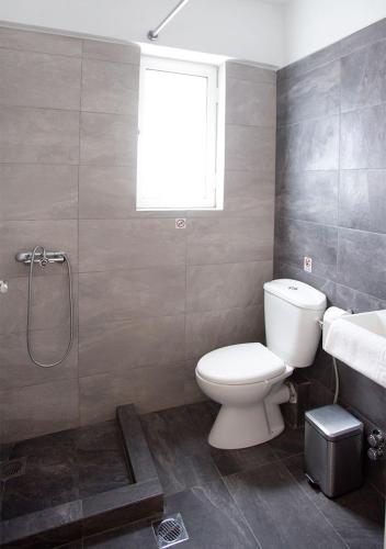 a bathroom with a toilet and a sink and a shower at Snooze H in Athens