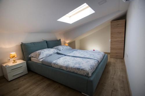a bedroom with a bed and a skylight at Red Rose Apartment in Portorož