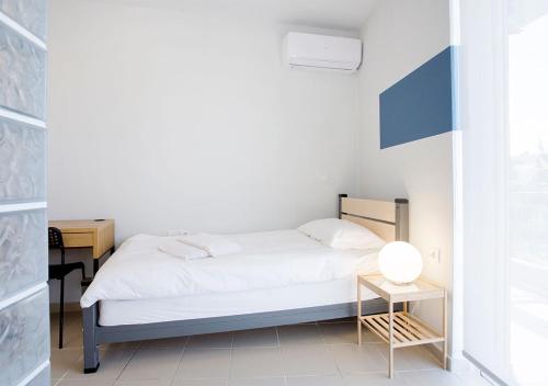 a small bedroom with a bed and a table at Snooze H in Athens